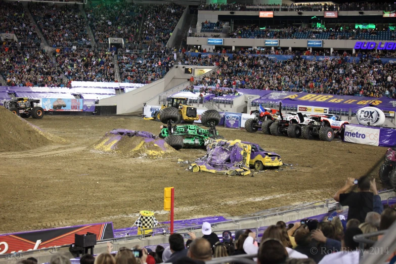 a dirt truck crashes while two people watch from the stands