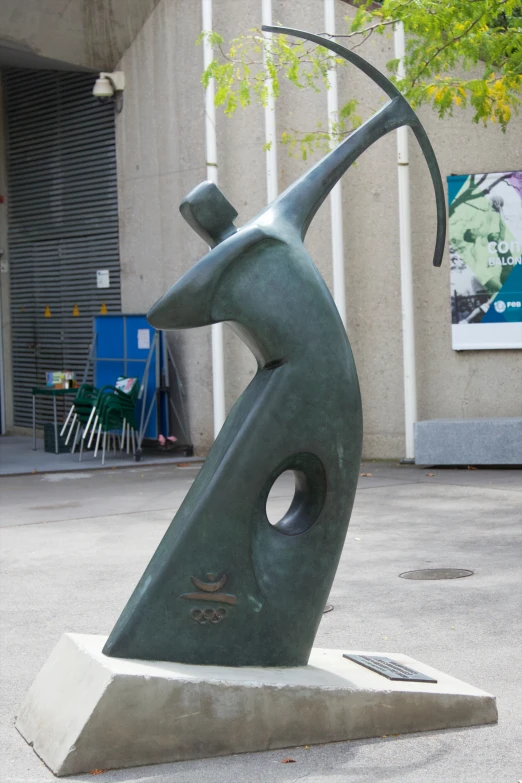 a statue is standing in front of a building