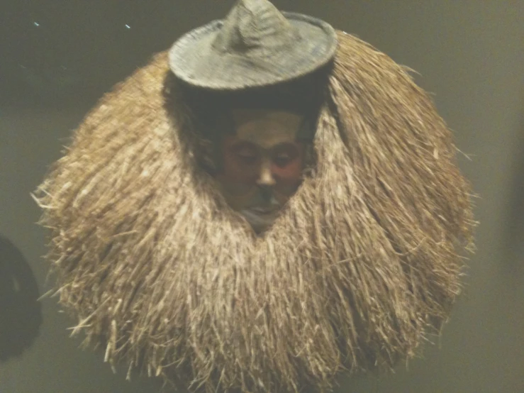 a man with straw hat in large window display