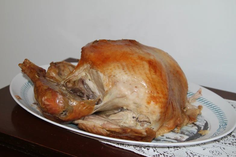 a roast turkey on a plate with lace