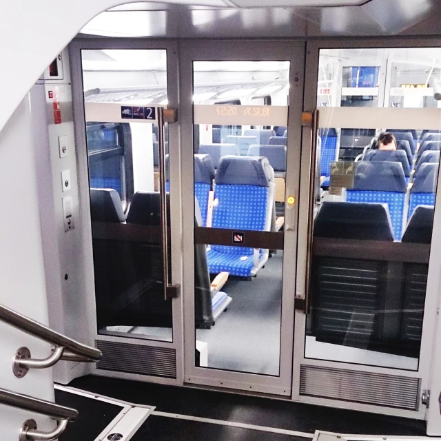 an airport interior with two metal doors