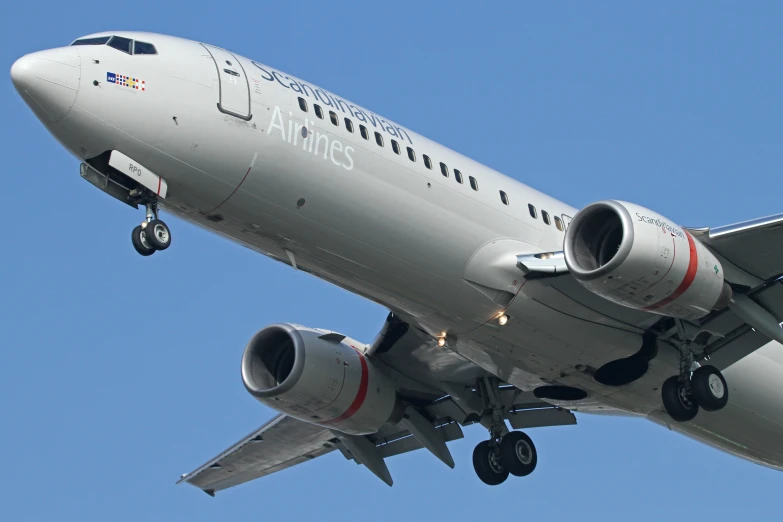 an airplane is in mid air against a blue sky