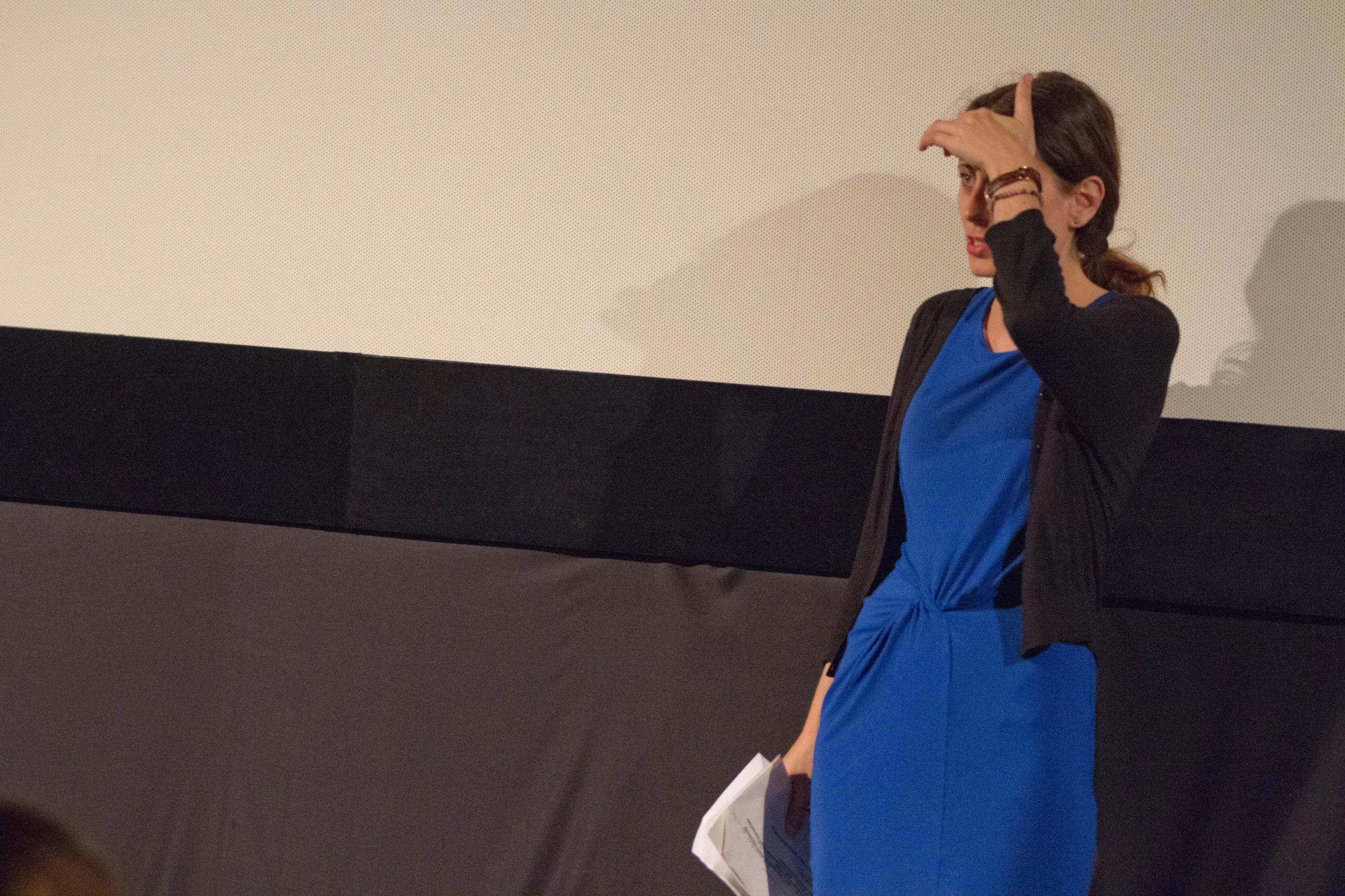 a person in a blue dress talks on his cellphone