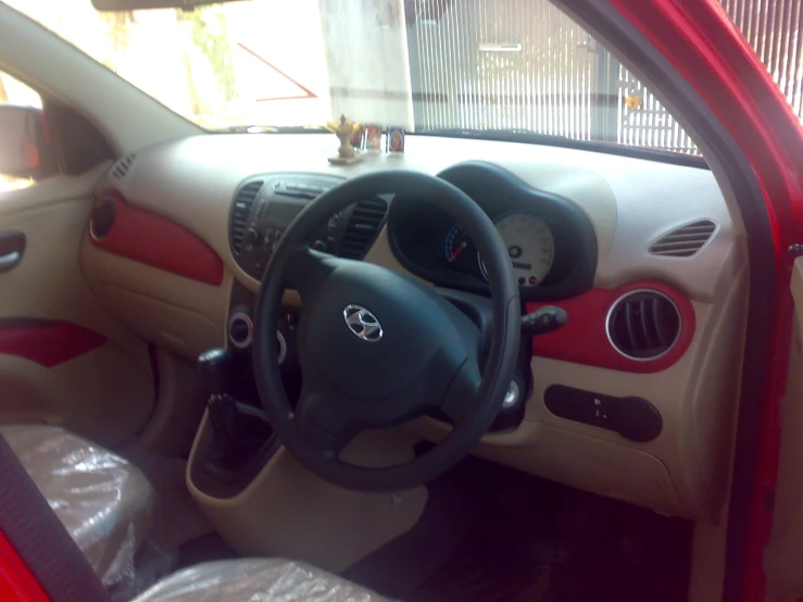 a car interior with steering wheel and dash board