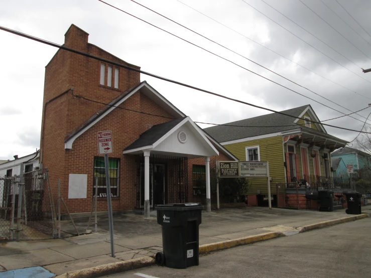 small brick church in rural location with buildings