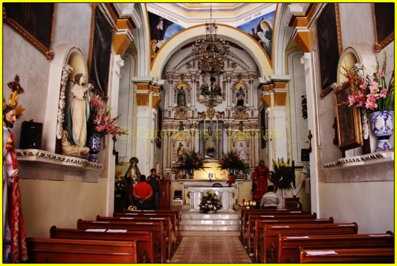 an ornate church with many wooden pews