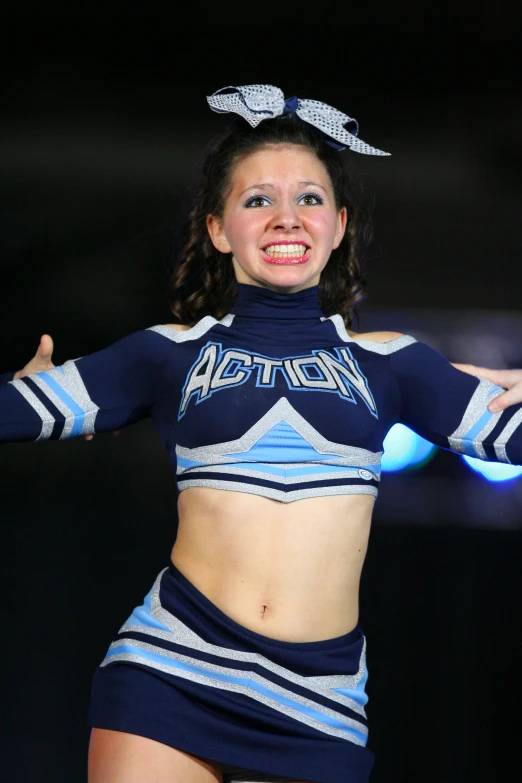 a cheerleader posing for the camera during a competition
