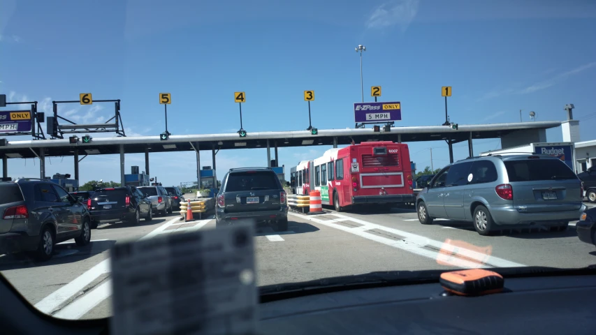 multiple vehicles wait for the bus to stop