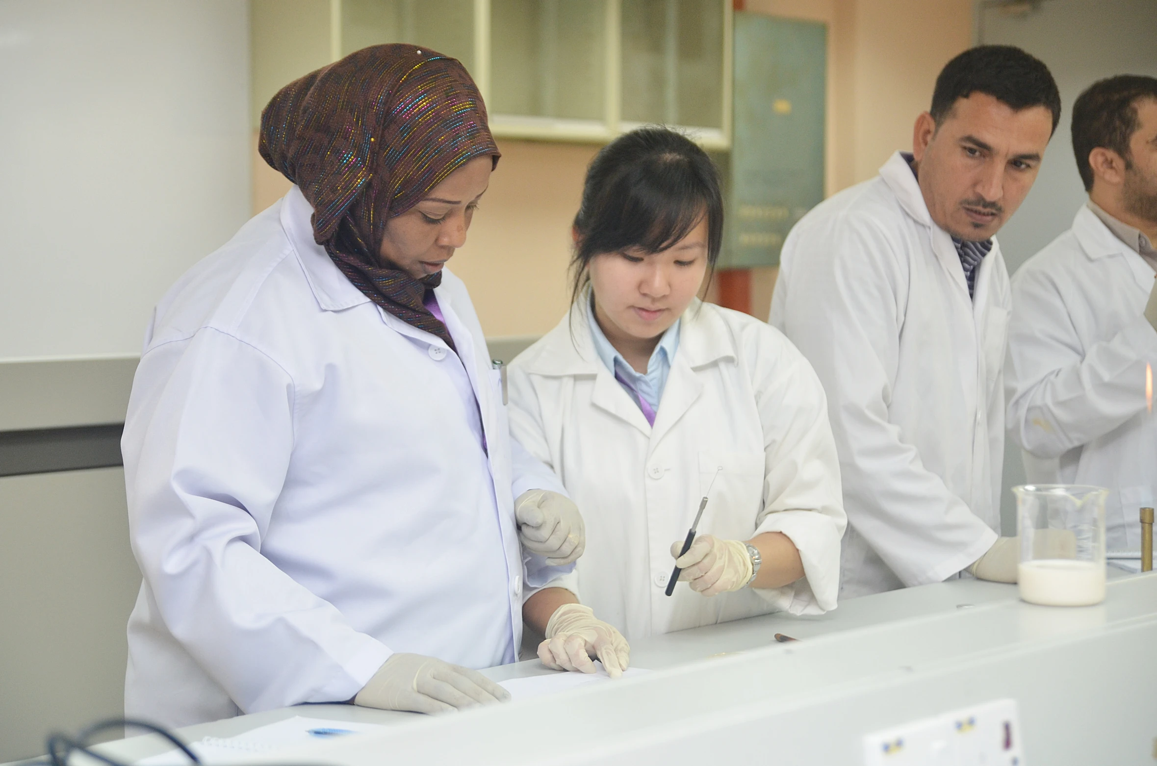 four medical professionals working in a laboratory