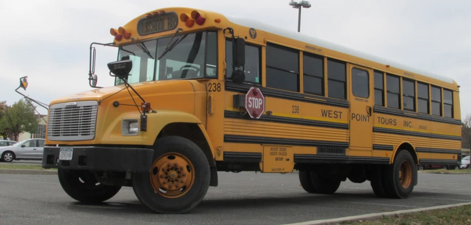 a yellow school bus driving down the road