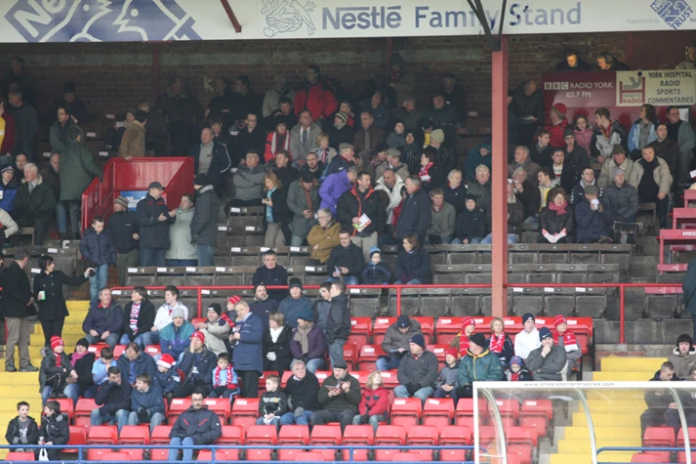 a crowd of people are in the stands at a soccer game