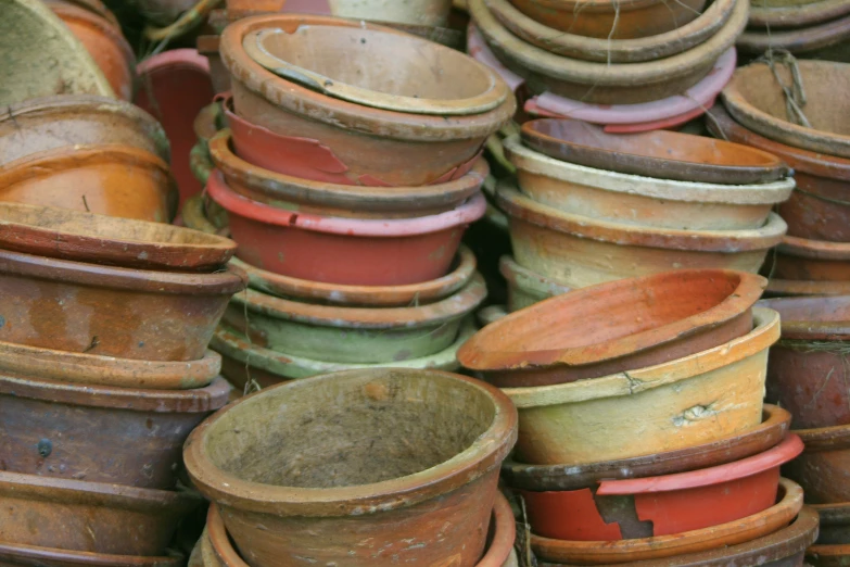 rows of colorful pots sit near each other in an assortment