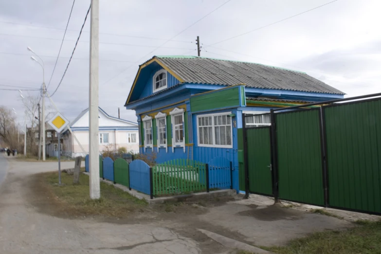 the blue house is painted a little yellow and green