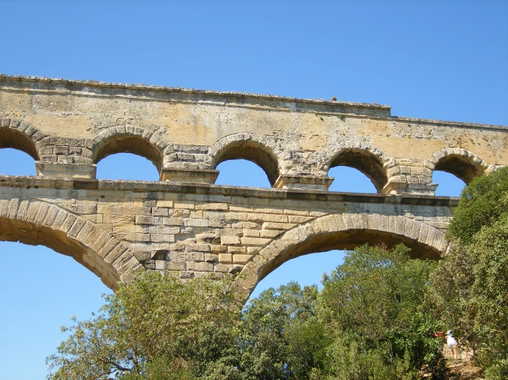 arched stone bridges above trees on a sunny day