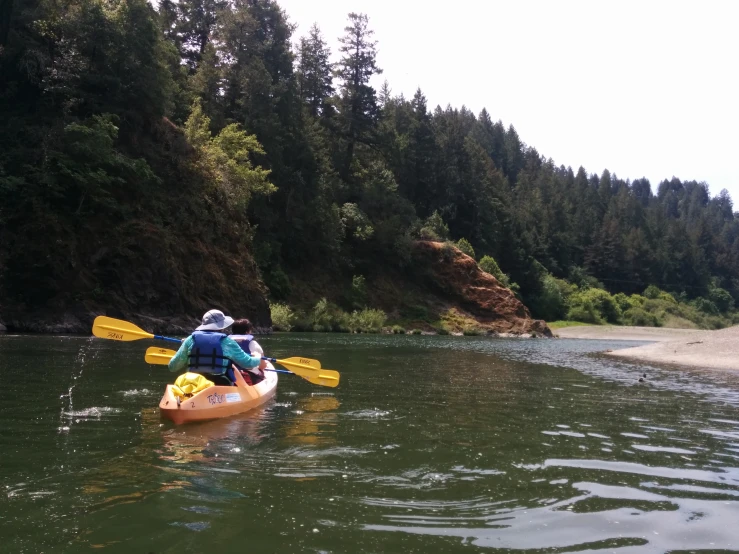 two people are in canoes on a large body of water