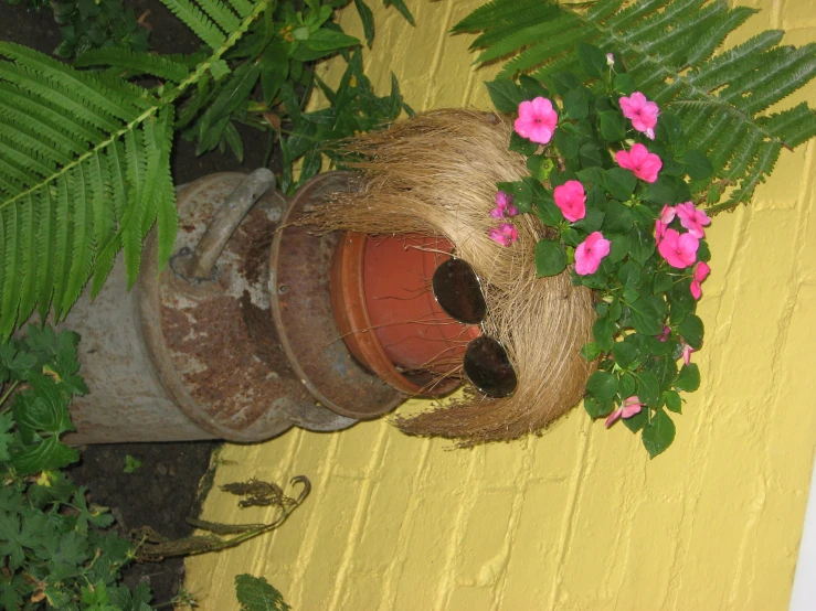 a planter with flowers in it is decorated with a straw cover