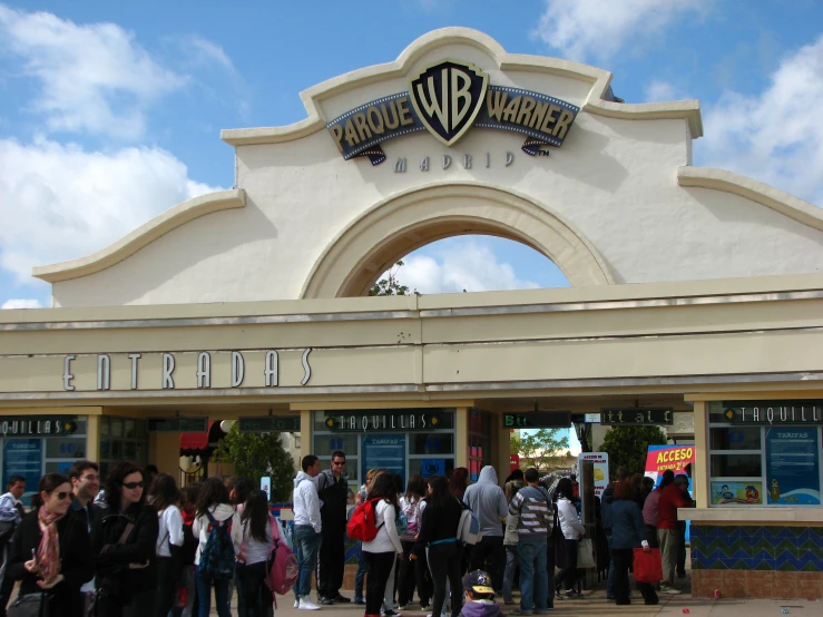 a crowd of people standing outside of a store