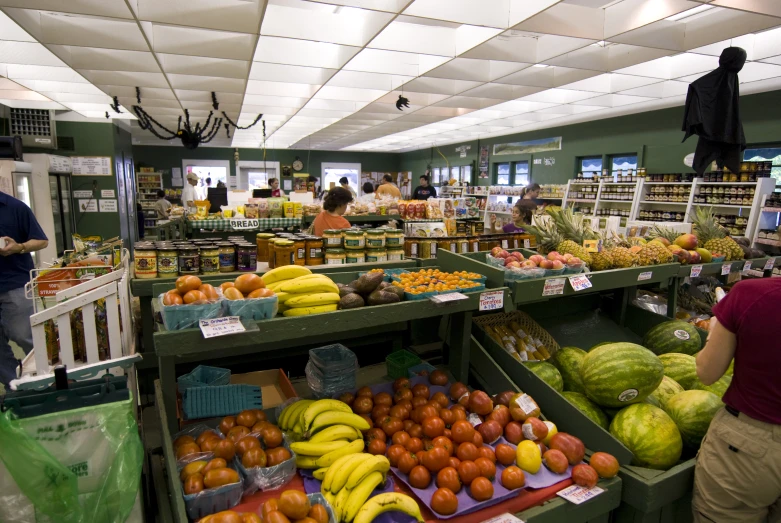 a store with green shelves filled with fruit