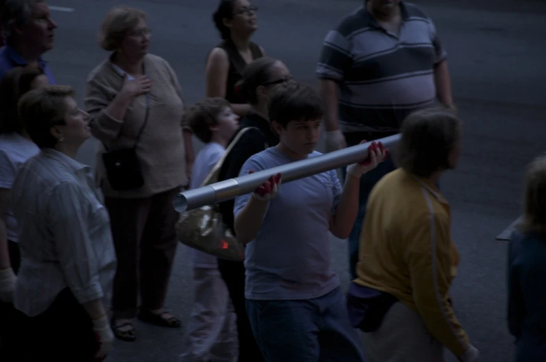 several people walk near one another in the dark