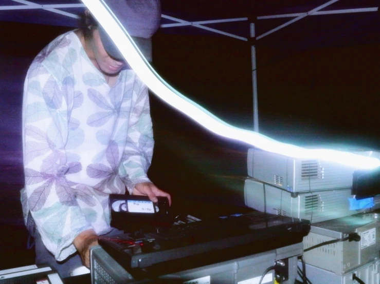 a man standing next to a sound board