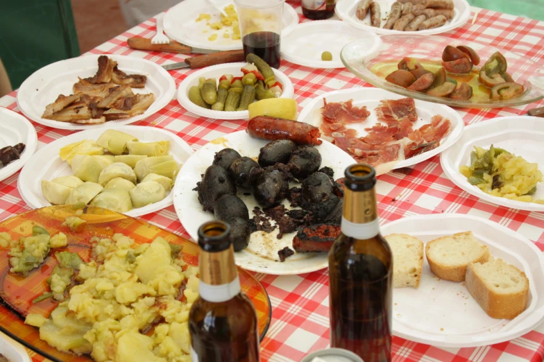 food spread out on paper plates on a table