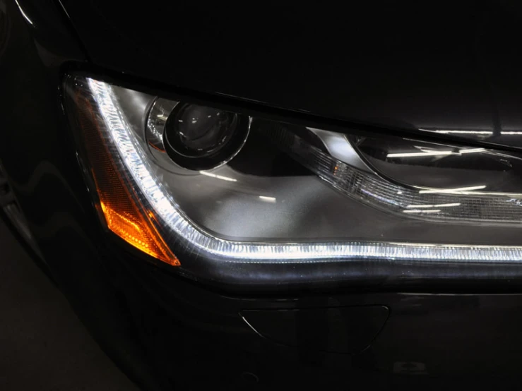 an illuminated close up on the front end of a car