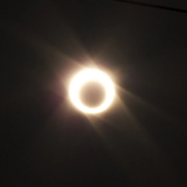 the moon and some very bright flashes in the dark sky