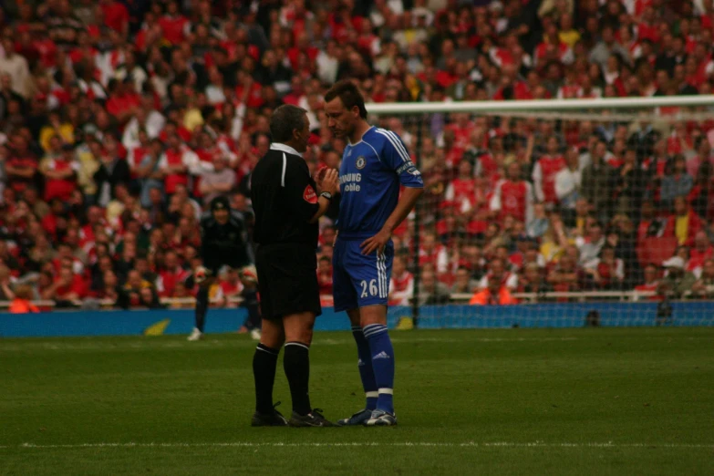 two men on a field talking to each other