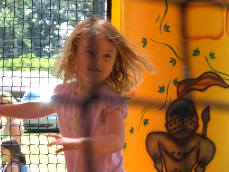  swinging a tennis racquet in playground area