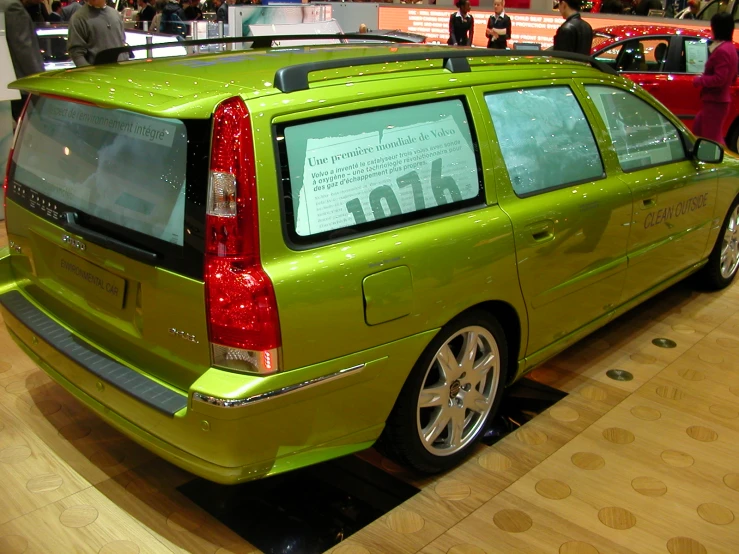 a green minivan with writing on the window