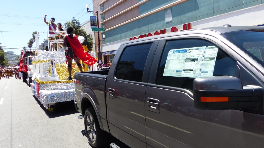 a parade float being pulled down the street with people in it