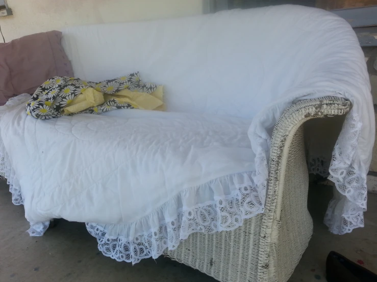 a white chair covered in lots of pillows