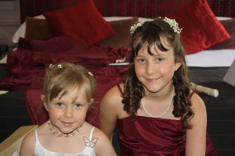 two s dressed in red dress standing next to each other