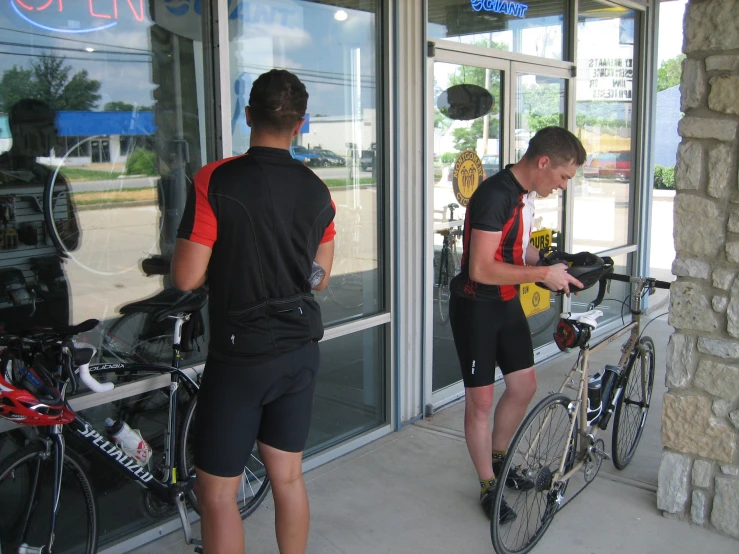 a couple of people with bikes and looking at their phones