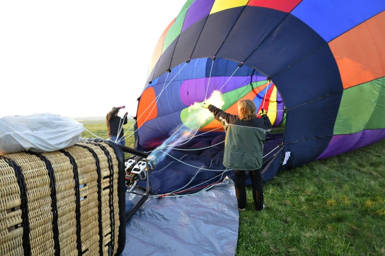 a group of people getting ready to release a  air balloon