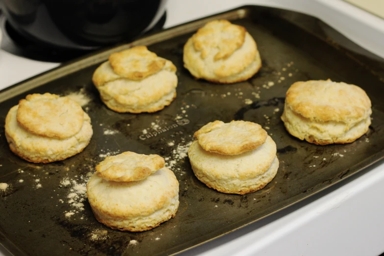 biscuits and biscuits are lined up on a baking sheet