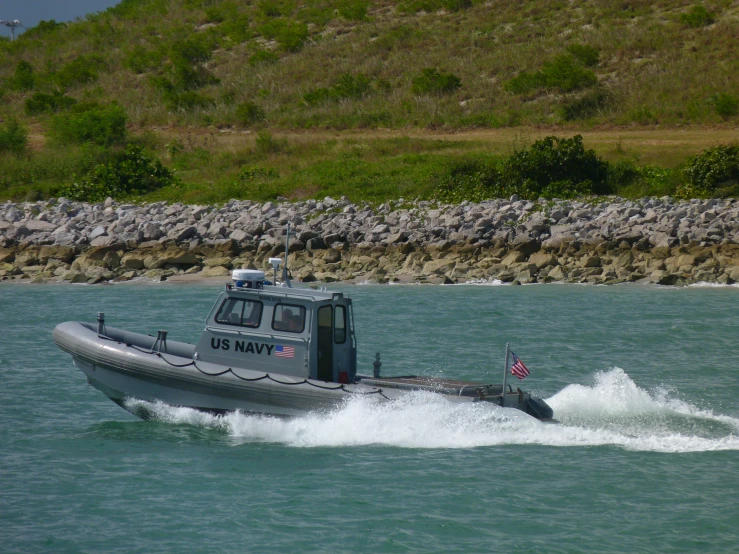 the small boat has its wheels moving through the water