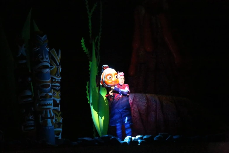 a puppet artist plays with a child in a scene from inside out
