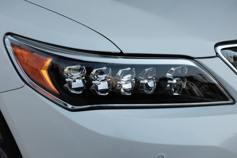 a headlight from a car shows the front lights