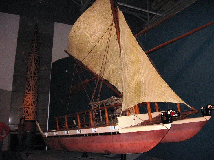 a model of a wooden boat is on display