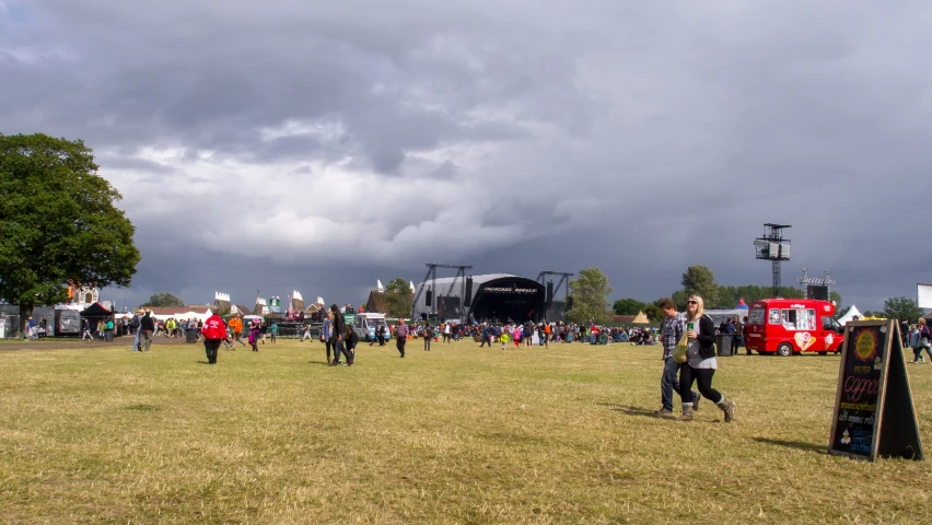 a couple of people standing on top of a grass covered field