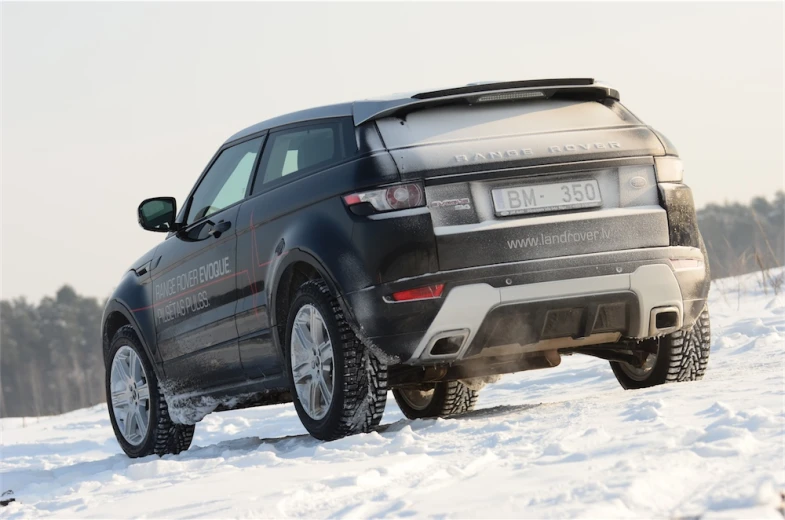 an off road range rover on snow covered ground