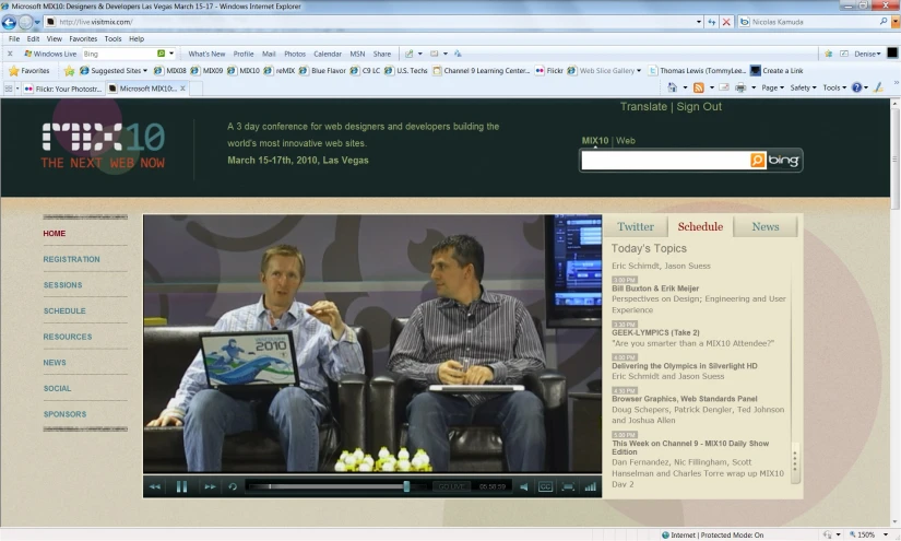 a web page with two men sitting in front of a screen