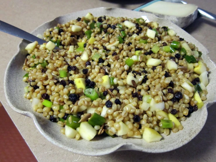 a plate is sitting on a table with some food in it