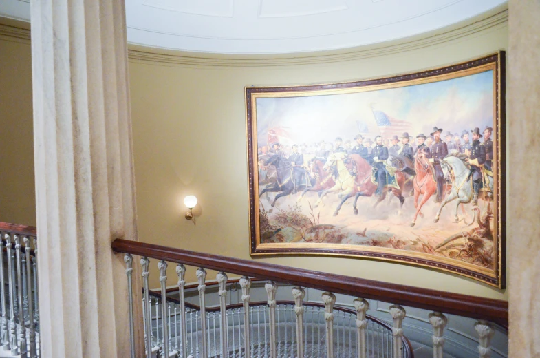 a mural of a battle scene with the end of a stair case