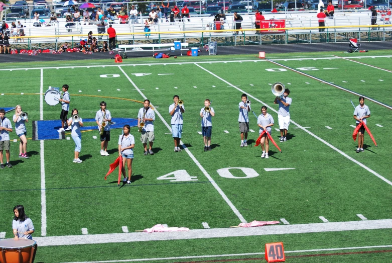 s are marching on the field in front of a crowd