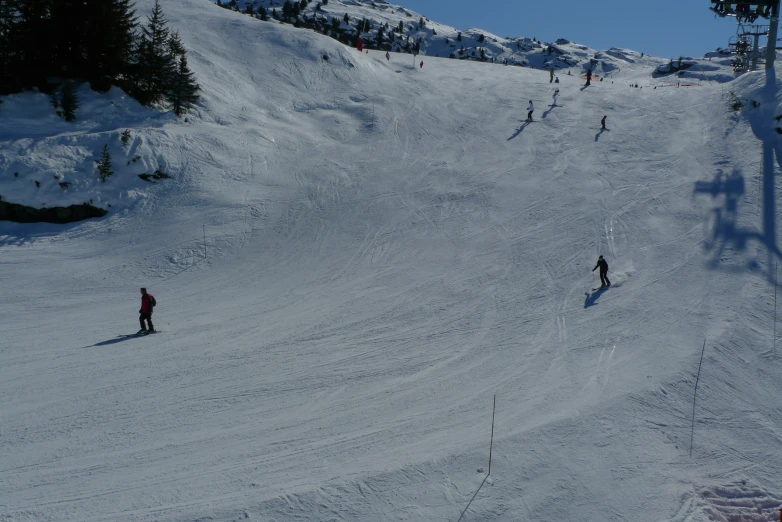 several people are skiing down the slope on skis