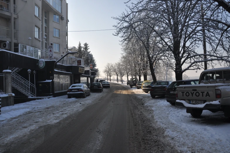 cars are parked on the street in front of the building