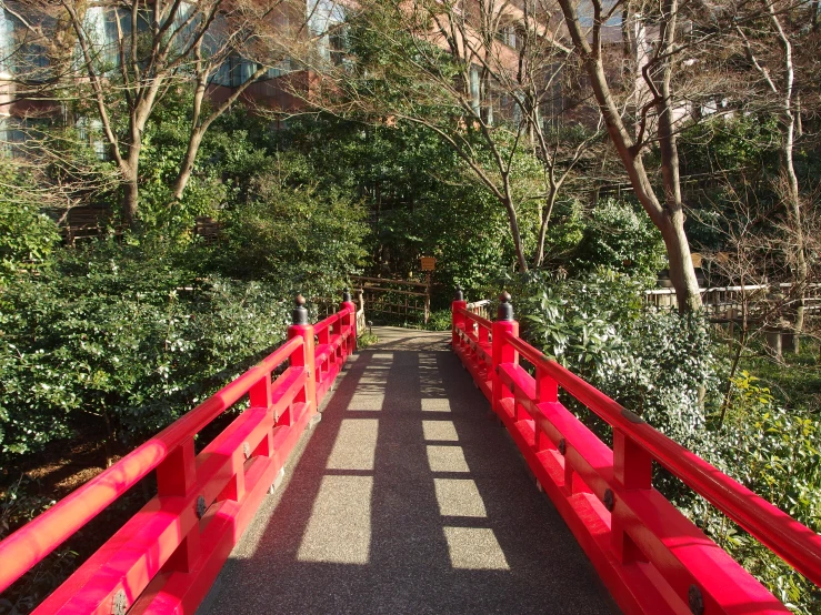 there is a red bridge that crosses the street