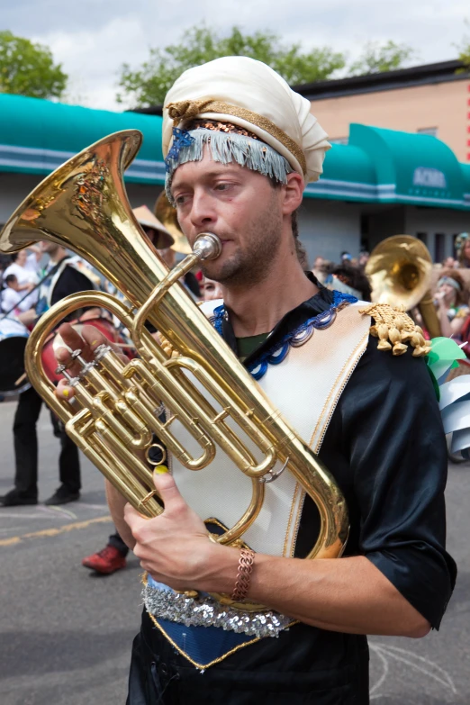 a marching man in full costume plays an instrument